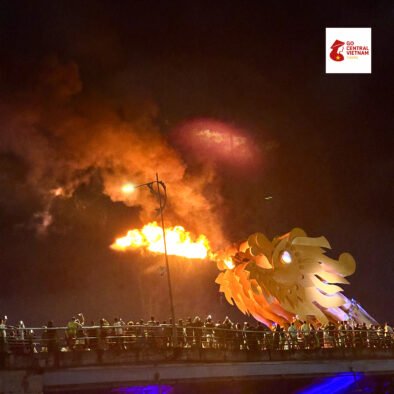 Iconic Dragon Bridge in Da Nang releasing a burst of fire during the evening show.