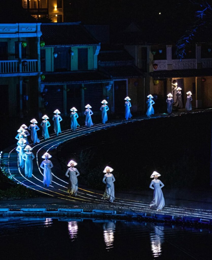 Women performing a cultural dance in flowing áo dài in Hoi An