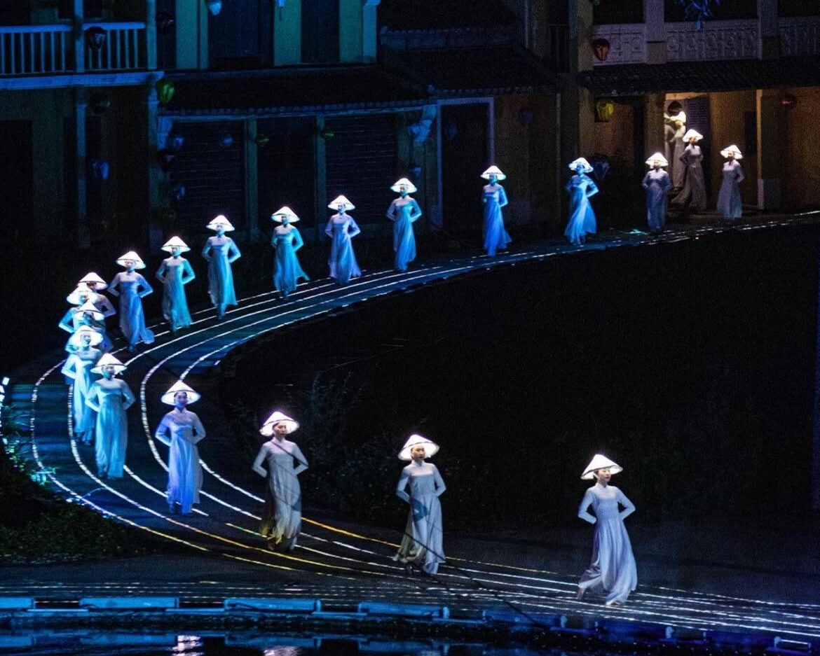 Women performing a cultural dance in flowing ao dai